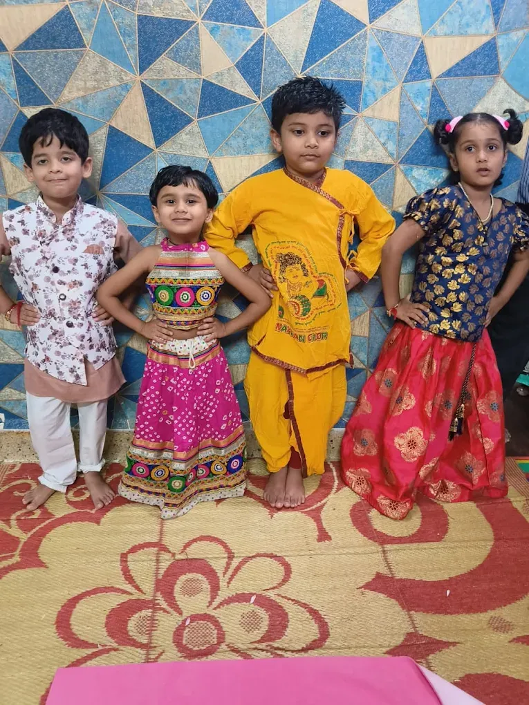 Four children dressed up in traditional festival clothes at Maza Ghar